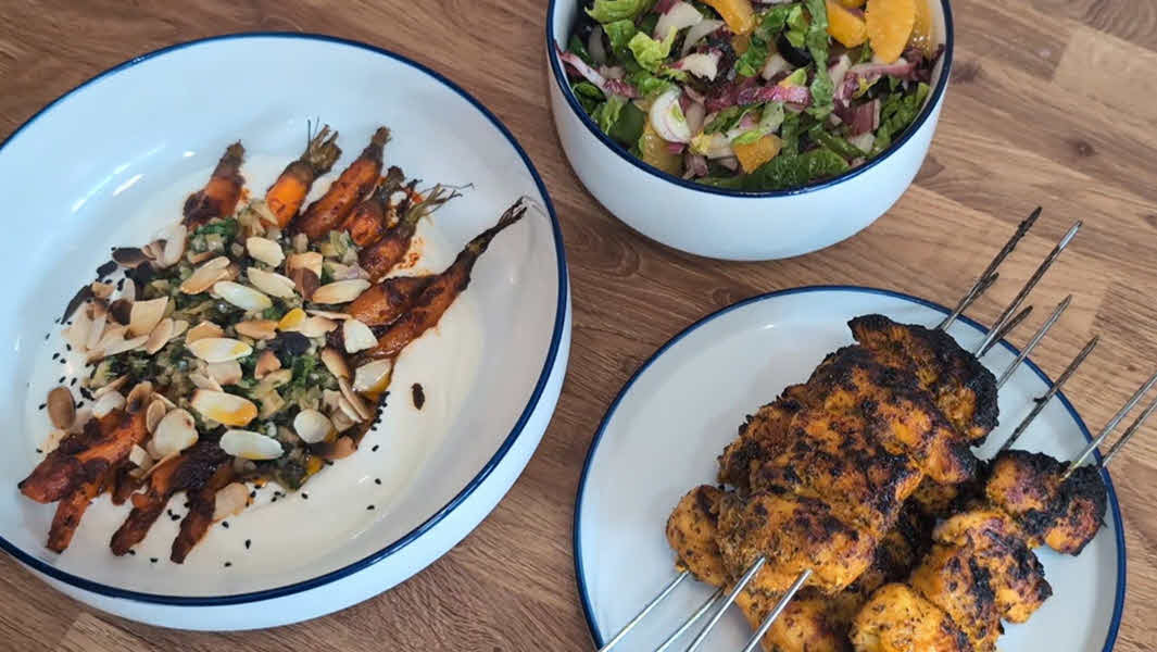 Sticky orange and turmeric chicken skewers, harissa roasted carrots and bitter leaf salad.