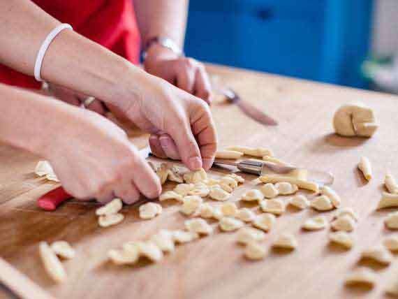 Cooking guests preparing home made pasta on cooking holiday. Cooking guests preparing home made pasta on cooking holiday in Amalfi.