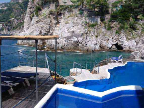 Outdoor pool at our Amalfi holiday villa. Outdoor pool at our Amalfi holiday villa surrounded by glittery sea.