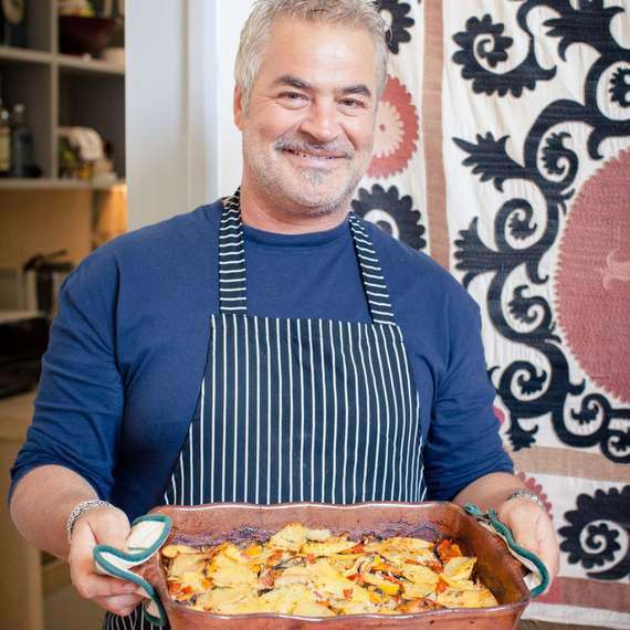 Flavours chef Antonio holding freshly prepared food. Flavours chef Antonio holding freshly prepared food.