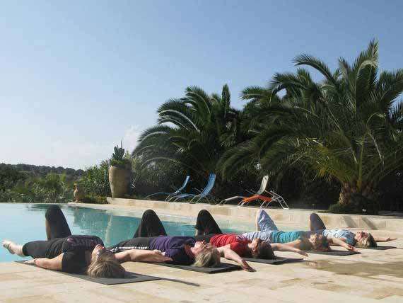 Pilates group relaxing in sun Pilates students relaxing by the pool after tailor-made class